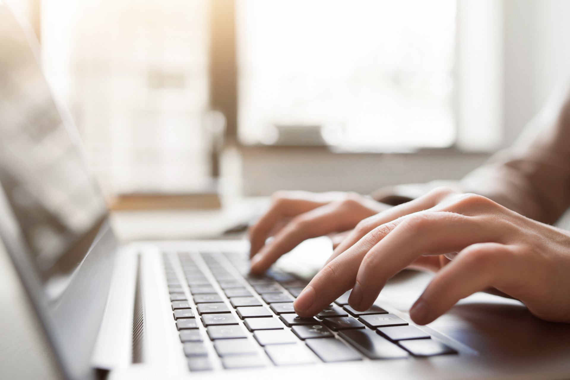 Writer typing content on a laptop