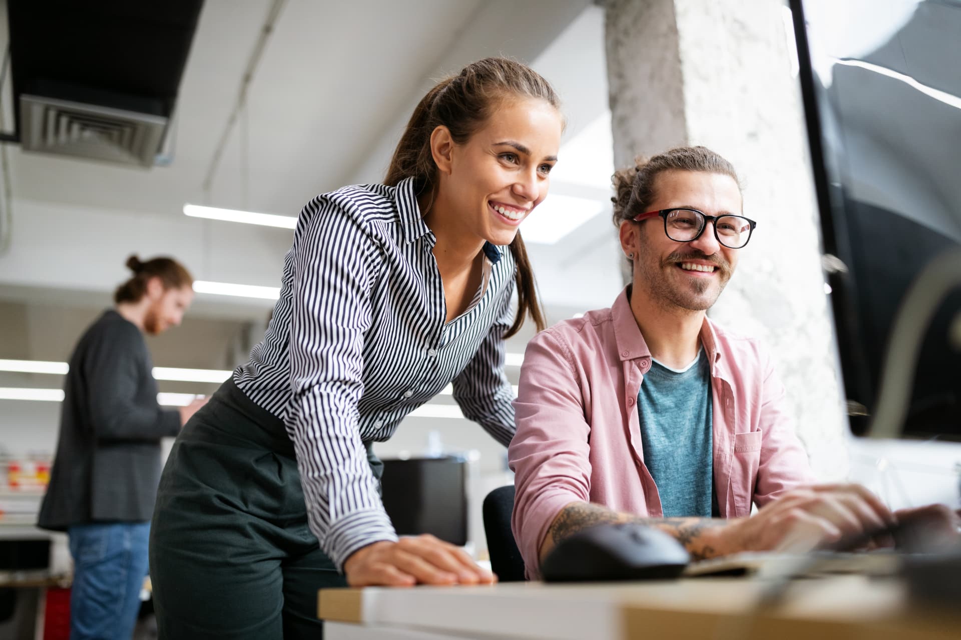 Two Wolfpack marketers reviewing campaign work together at a computer
