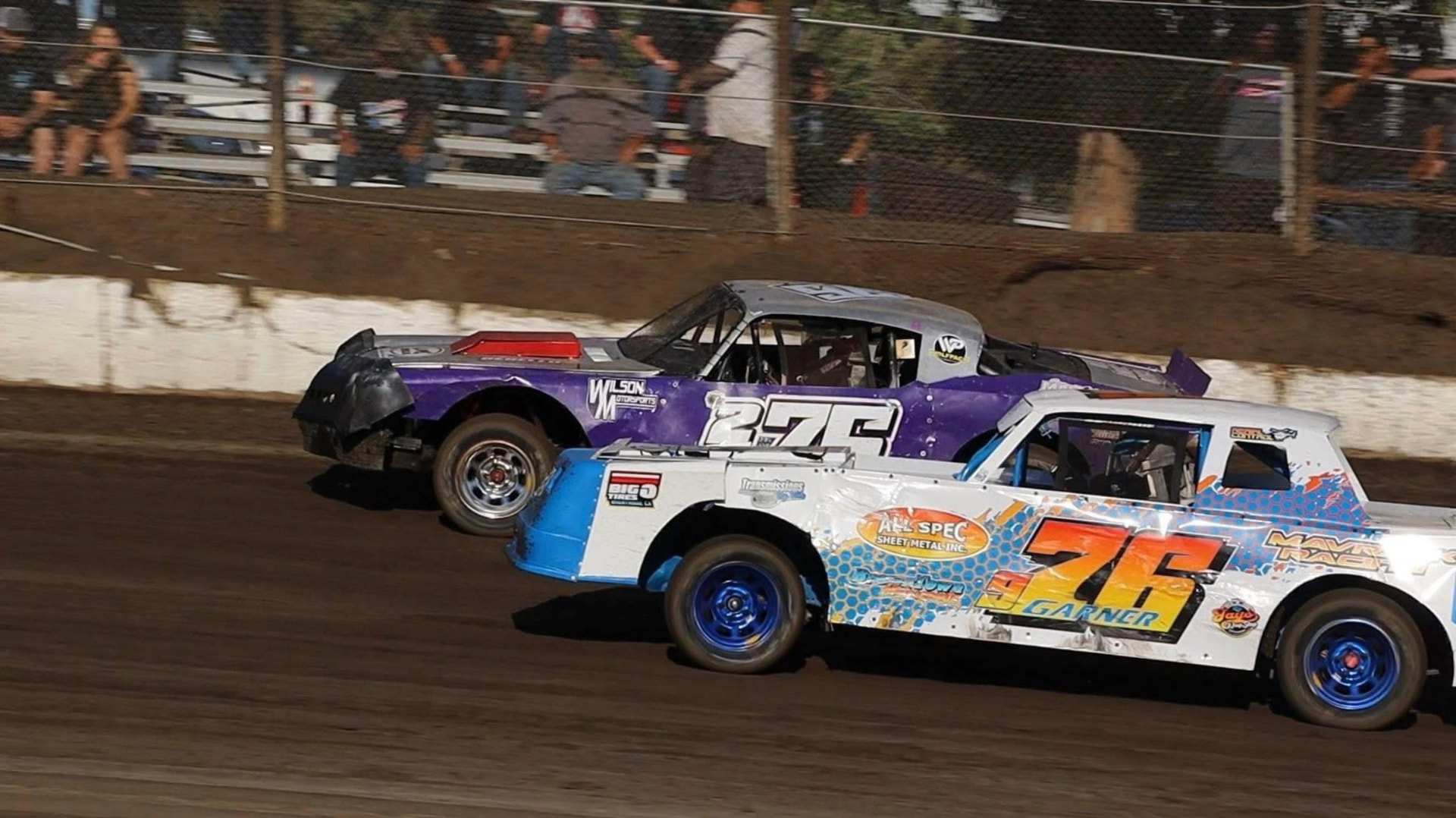 The purple No. 276 Hobby Stock racing door to door at Antioch Speedway